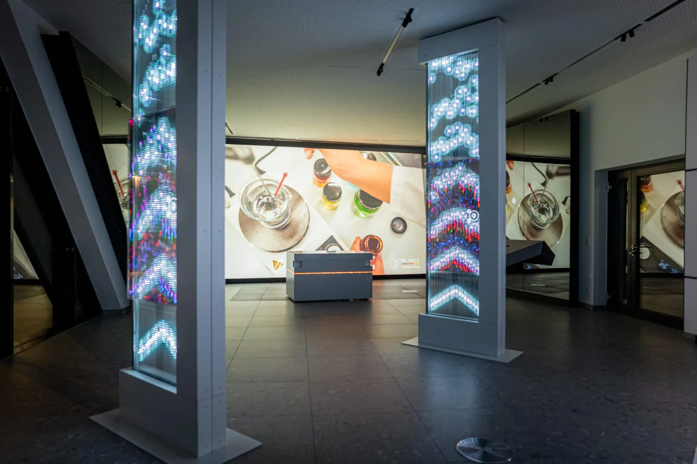 Immersive space with projections, futuristic stations, and interactive elements