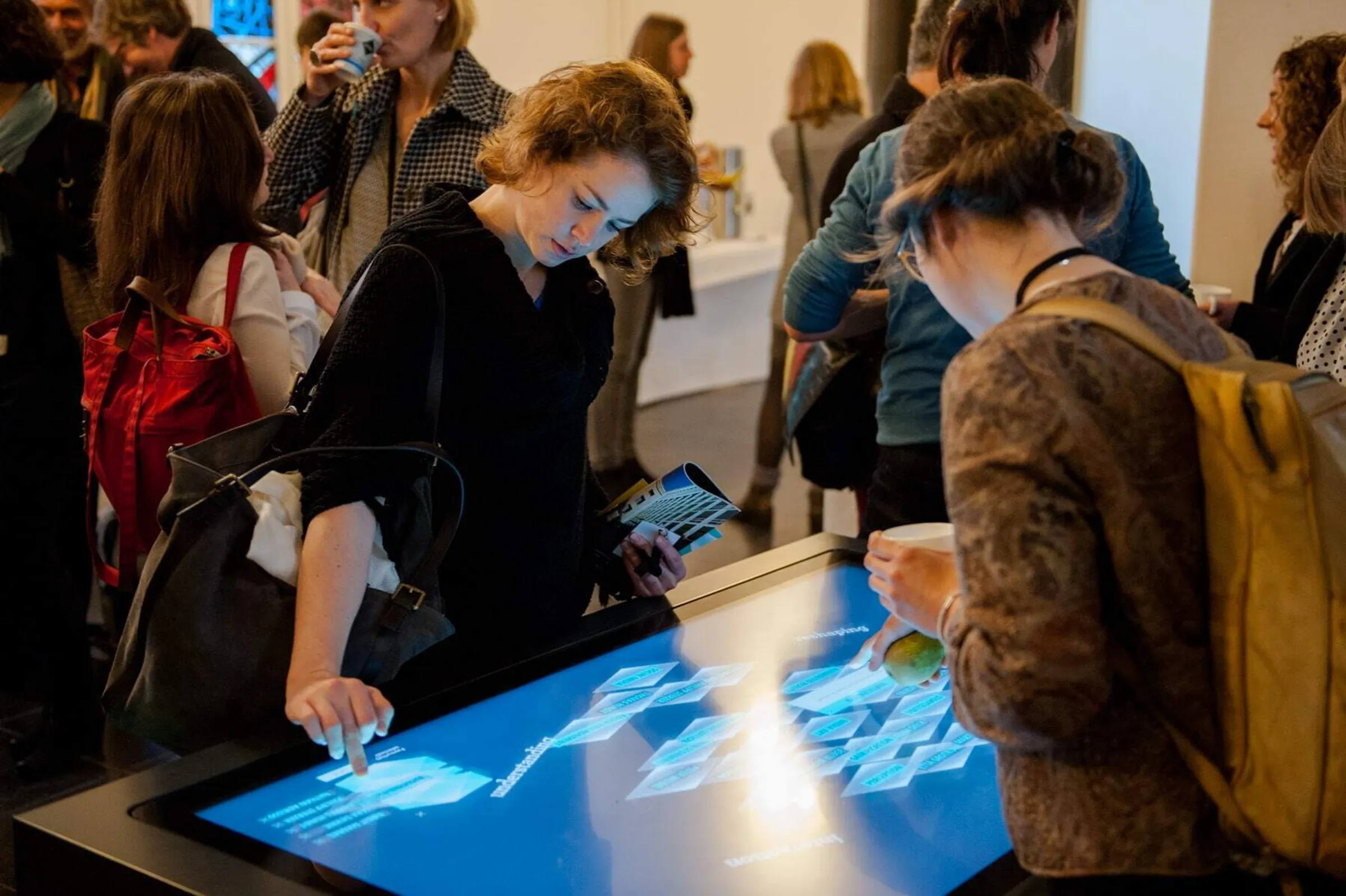 Museum visitors at the multi-touch scanner table Media conference Humboldt Forum