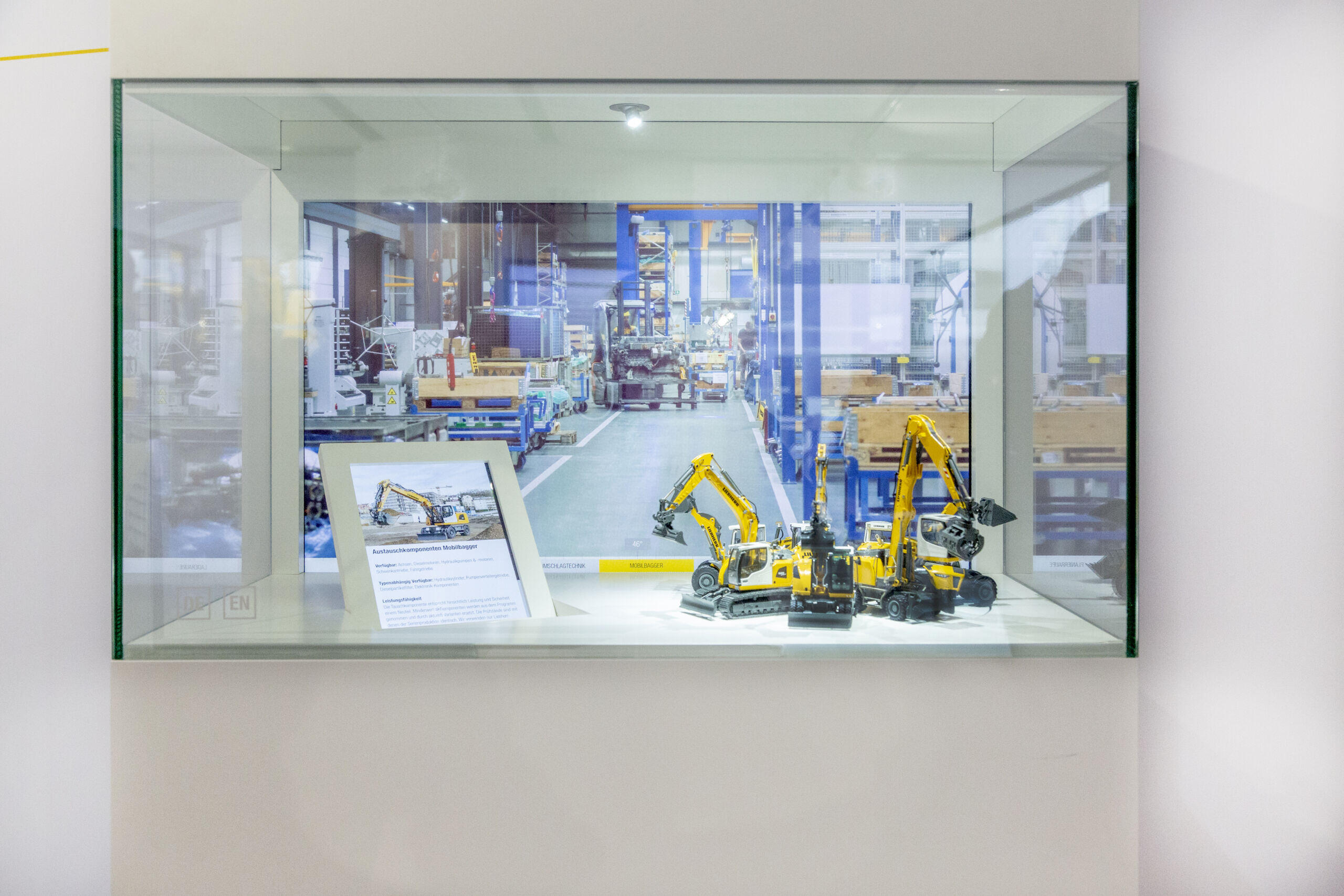 Select excavator by swiping gesture on the showcase glass and receive information on two monitors