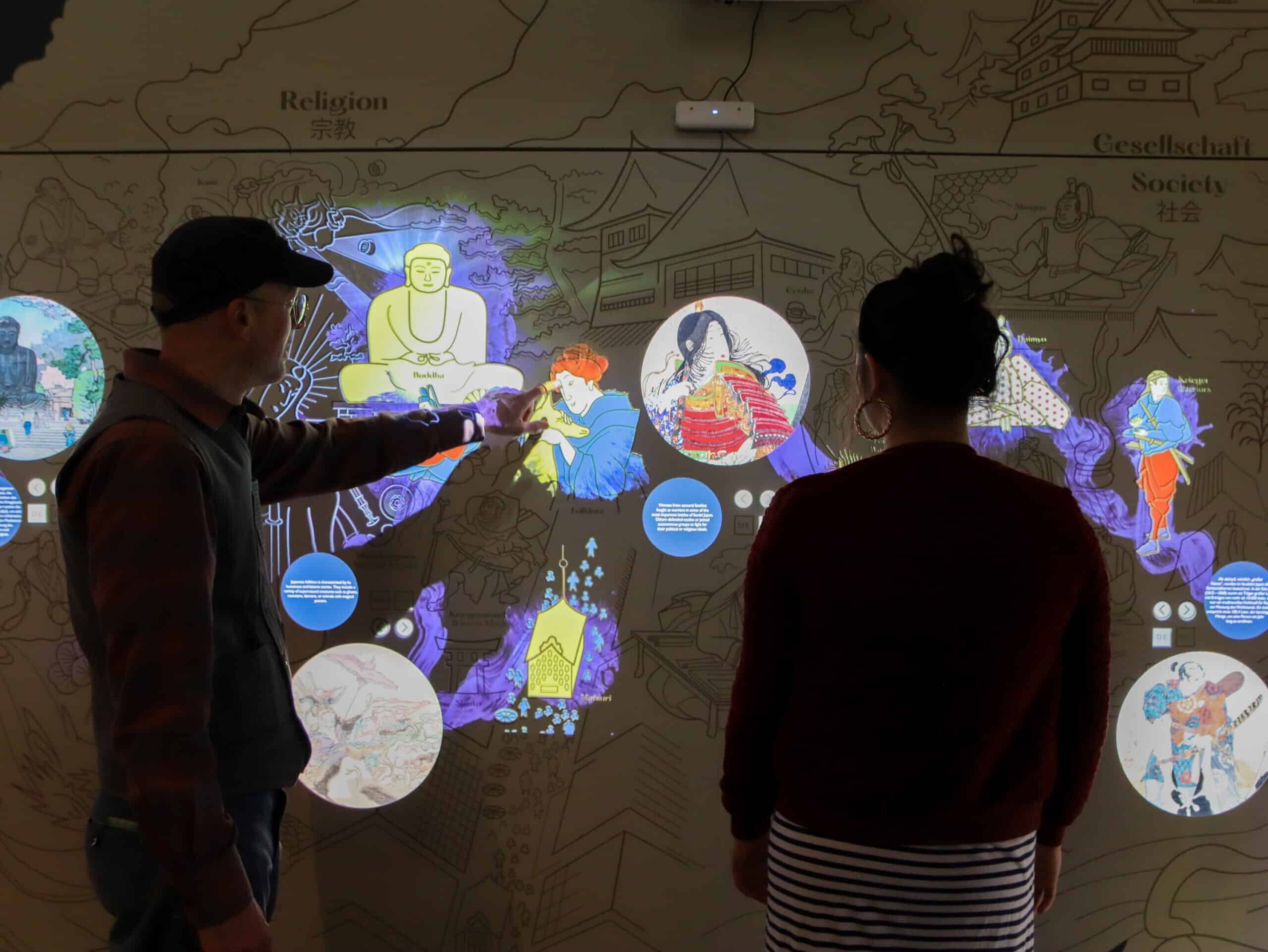 Interactive wall with projection mapping and touch screens